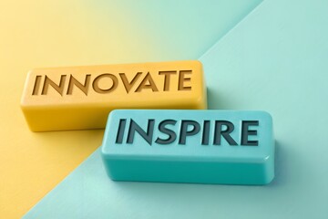 3D-printed Glossy Plastic Blocks with 'INNOVATE' and 'INSPIRE' in Bold Black Letters on Turquoise-Yellow Gradient