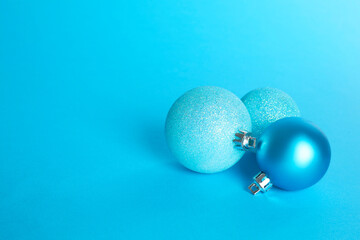 Beautiful Christmas balls on light blue background, space for text