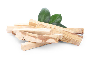 Pile of palo santo sticks and green leaves on white background