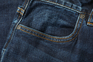 Stylish dark blue jeans with pocket as background, top view