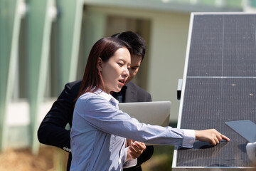 Solar Technology and Renewable Energy. A professional explaining solar panel functionality to a...