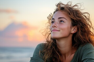 A trans woman enjoying a beach sunset, wind in hair, peaceful expression