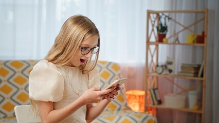 An astonished child joyfully interacting with a smartphone, completely captivated by it