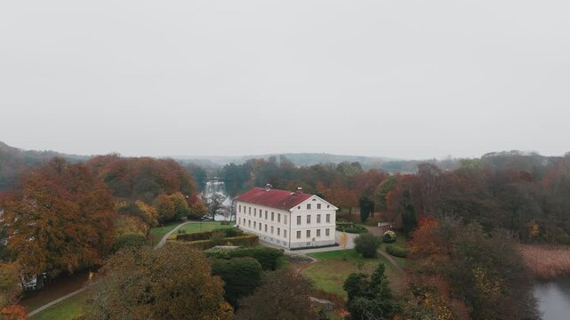 Gyllebo lake in South Sweden, Sk&aring;ne, &Ouml;sterlen at Autumn with yellow and orange leafs, mansion, fog mansion