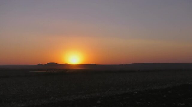 fast, dust trails wind sunset over hills mountain range landscape africa, dam lake on dry landscape, ecosystem capturing the beauty of nature