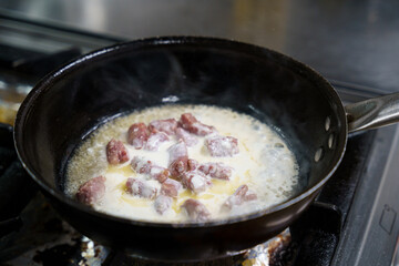 Cooking Meat in Cream Sauce on Stove