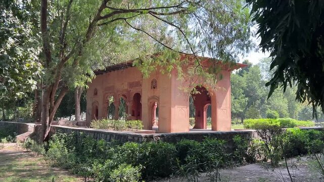 Arched building surrounded with green-leafed trees in Picnic hut Park in Ashok Vihar, Delhi, India