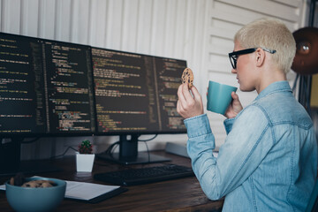 Young woman in casual denim working on programming at home office