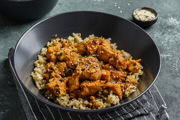 chicken in curry sauce with rice and sesame seeds