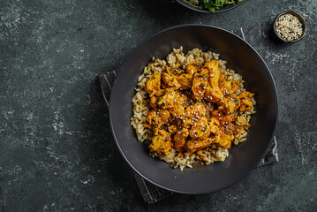 chicken in curry sauce with rice and sesame seeds