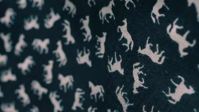 Black fabric with white horses fluttering in the wind. Closeup. Macro. Slow mo, slow motion, high speed camera, 200fps
