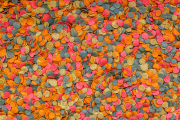 Aquarium fish fodder closeup.Food for aquarium fish in the form of colorful flakes.Top view