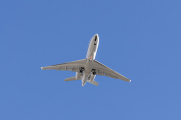 Commercial Airplane Flying Overhead Against a Clear Blue Sky