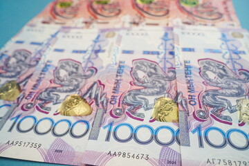 Banknotes of Kazakhstani tenge: 5000 and 10,000 are laid out on the table.
