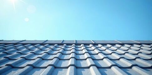 Grey roof tiles against clear blue sky Sunlight illuminates textured surface , house, architecture