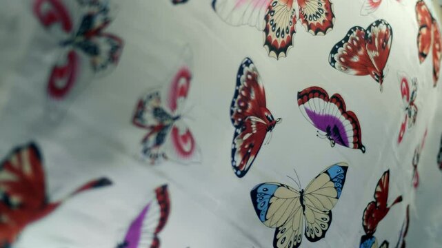 White fabric with beautiful butterflies flutters in the wind. Closeup. Macro. Slow mo, slow motion, high speed camera, 200fps