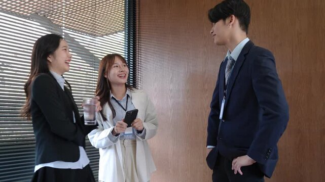 Young startup professionals engaging in a casual and relaxed conversation during their office break, fostering workplace friendships and strengthening team collaboration in a modern business setting