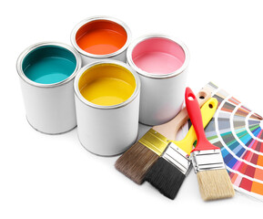 Cans of bright paints, brushes and color palettes isolated on white