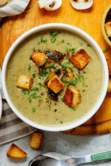 Creamy champignon soup with croutons.top veiw