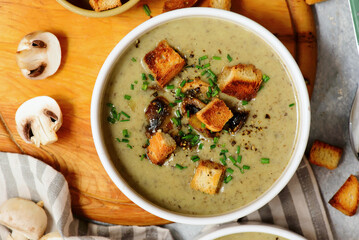 Creamy champignon soup with croutons.top veiw