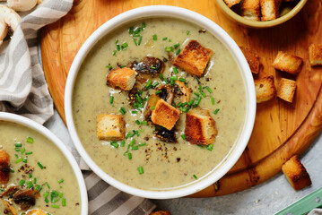 Creamy champignon soup with croutons.top veiw