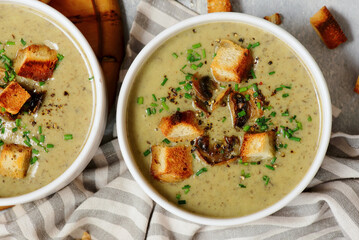 Creamy champignon soup with croutons.top veiw