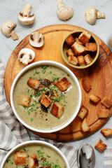 Creamy champignon soup with croutons.top veiw