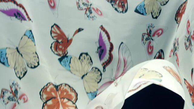 White fabric with beautiful butterflies falls, fluttering on a black background. Closeup. Macro. Closeup. Macro. Slow mo, slow motion, high speed camera, 200fps
