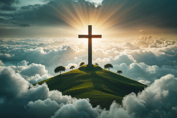 Croce cristiana sulla cima di una montagna circondata dalle nuvole e illuminata dalla luce del sole al tramonto
