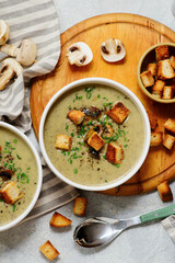 Creamy champignon soup with croutons.top veiw