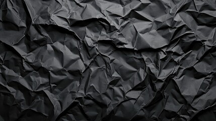 Black crumpled paper texture with copy space.