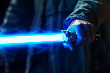 Close up of light saber in hand, Science fiction novel