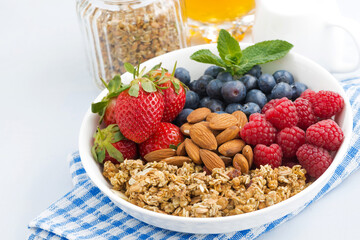 healthy nutritious breakfast with cereal and berries on white background, closeup