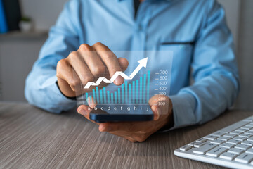 Concept of economic growth. Businessman analyzing investment and growth data using a mobile app