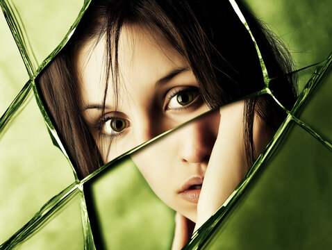 beautiful woman reflection in a broken mirror