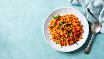 Bulgur Turkish style with tomatoes. Blue background. Copy space. Top view.