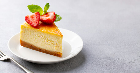 Cheesecake dessert with fresh strawberries. Grey background. Close up. Copy space.