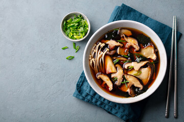 Miso soup with mushrooms. Traditional asian food. Grey background. Copy space. Top view.