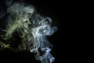 Smoke swirls in the dark, creating ethereal patterns of light and shadow, evoking mystery and tranquility in the stillness of the night