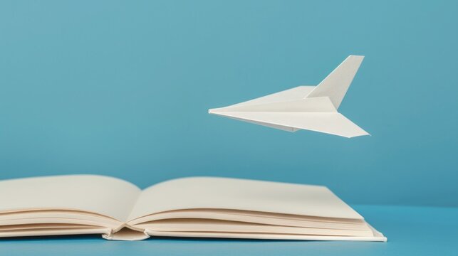 A paper airplane taking off from an open book symbolizes learning as a journey to success. Sharp depth and well-balanced contrast.