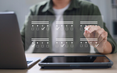 assessment survey online. Businessman with evaluating questionnaire on online laptop computer....