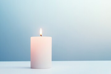 single lit candle resting on simple white surface symbolizing enlightenment and peace with ample copy space surrounding