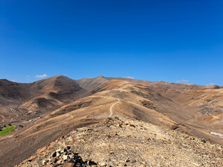 trekking route in the mountainous terrain of Fuerteventura, an endless road
