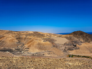 mountainous terrain on Fuerteventura, view from above of the southern coast of the island, volcanic landscape in the distance visible ocean