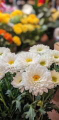 Fototapeta premium Beautiful Close-Up of White Chrysanthemum Flowers in a Vibrant Flower Market Setting with Blurred Colorful Background Elements