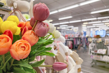 Artificial tulip flowers in a store. Colorful plastic floral decorations for home decor. spring and summer shopping trends with vibrant imitation flowers.