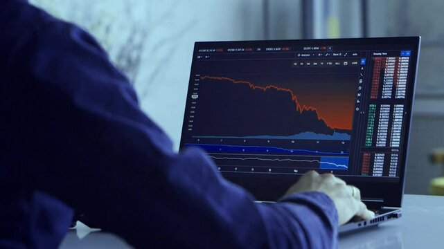 A trader watches the chart of a cryptocurrency and trades on the exchange