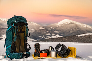 Overnight in a tent in the mountains in winter, camping equipment.