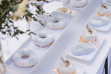 Dessert table for a party. Table beautifully decorated with sweet treats and wedding cakes.	
