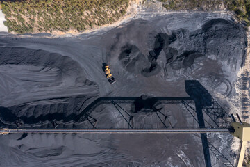 Drone aerial photograph of industrial machinery processing and moving crushed coal in a Colliery in...